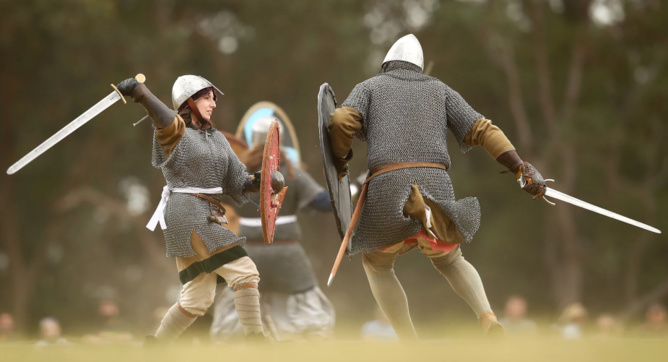 Combatants fight in a Viking re-enactment. Researchers have now shown real Vikings might have been buried with Islamic symbols. Photograph: Mark Kolbe/Getty Images