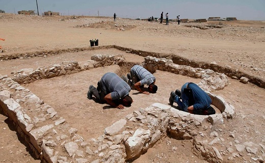 Muslim workers of Israel's antiquities authority pray at the newly discovered remains of an ancient rural mosque, dating back to the era between the 7th and the 8th centuries, in the Israeli Bedouin town of Rahat in the Negev desert on July 18, 2019. AFP